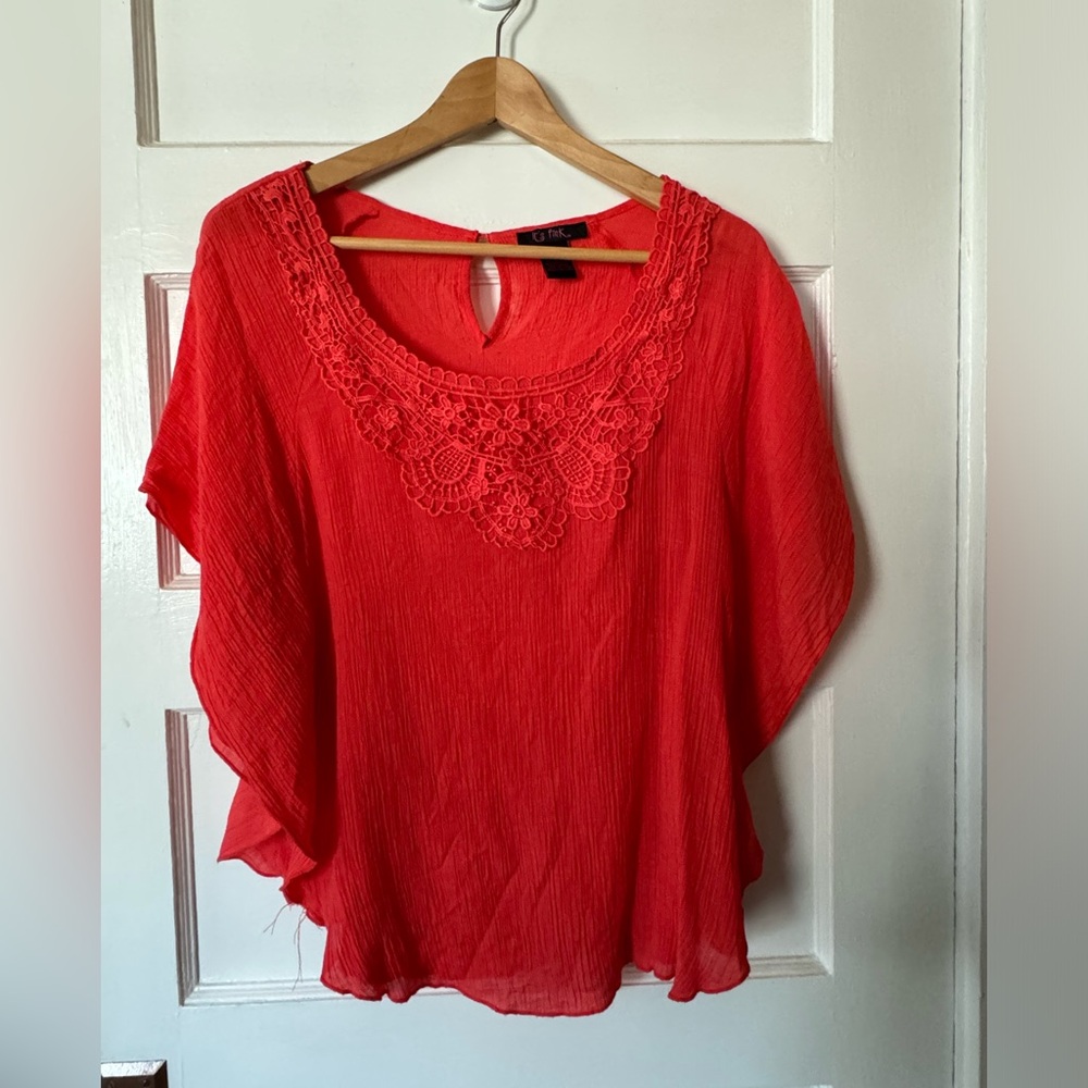 Orange short sleeved top with crochet detail, fits like a medium